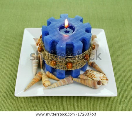 Blue marine styled candle with seashells and hessian band.