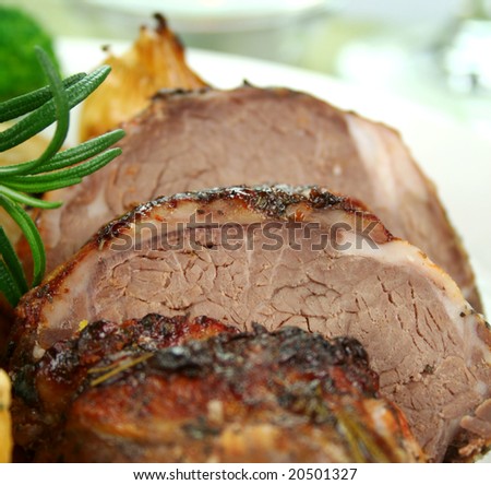 Sliced baked lamb with rosemary ready to serve.