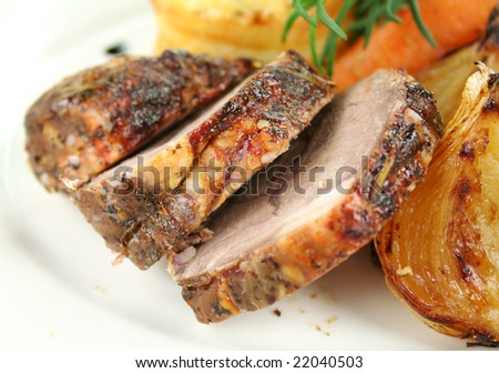 Sliced baked lamb with rosemary ready to serve.
