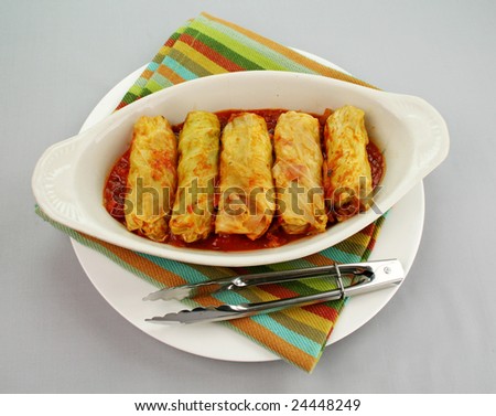 Piping hot baked cabbage rolls with a tomato sauce ready to serve.