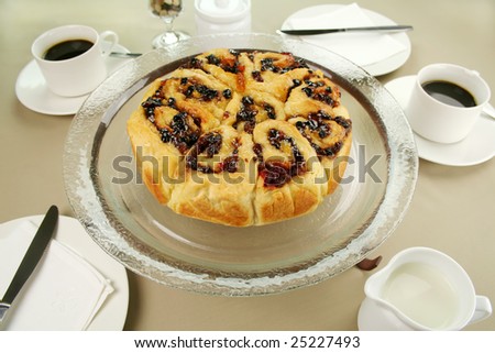 Delicious chelsea bun with dried fruit served with coffee