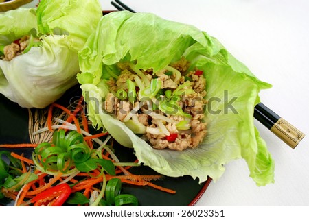 Delicious San Choy Bow with minced chicken and Chinese vegetables wrapped in fresh lettuce leaves.