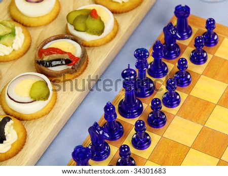 Finger food laid out with a game of chess for a games night.