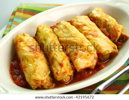 Piping hot baked cabbage rolls with a tomato sauce ready to serve.