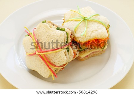 Healthy kids sandwiches cut in the shape of a star and tied up.