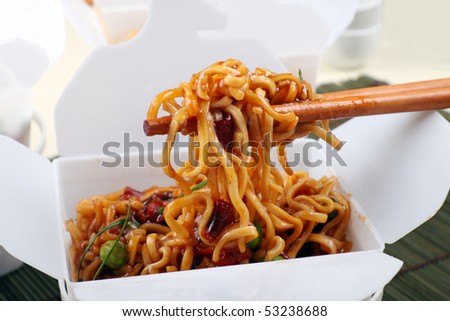 stock photo : Take away BBQ egg noodles on chopsticks in a take away 