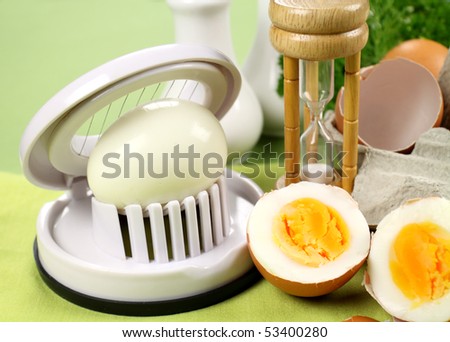 Egg slicer with boiled eggs and an egg timer.