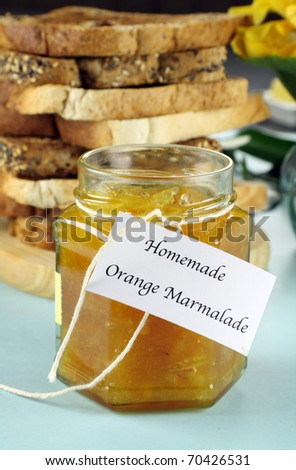 Jar of fresh homemade orange marmalade jam ready to serve.