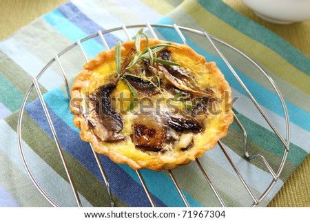 Mushroom quiche on a baking rack straight from the oven.