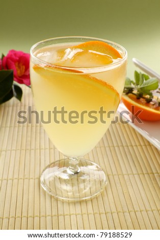 Sweet orange cocktail with ice and slices of fresh orange ready to serve.
