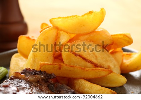 Crisp Golden potato wedges served with steak and ready to eat.