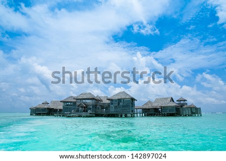 Maldives.Villa on piles on water,Island in ocean