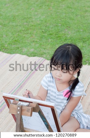 asian young girl painting in the park