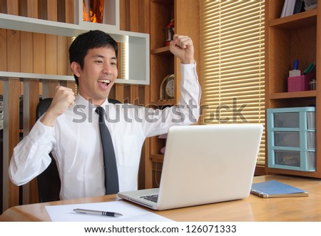 asian happy man with laptop