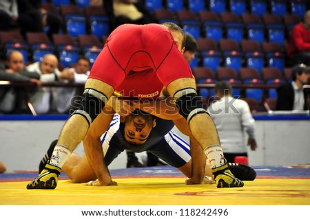 MINSK, BELARUS - SEPTEMBER 16: Unidentified wrestler (RED) in the dangerous position during Grand Prix for the prizes A.Medved in freestyle wrestling on September 16, 2012 in Minsk, Belarus.