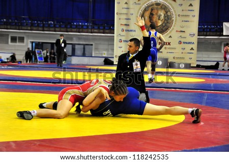 MINSK, BELARUS - SEPTEMBER 16: Unidentified female wins by fall during Grand Prix for the prizes A.Medved in freestyle wrestling on September 16, 2012 in Minsk, Belarus.