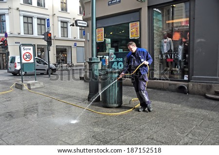 OSLO - AUGUST 16: Unidentified male cleaning street on August 16, 2012