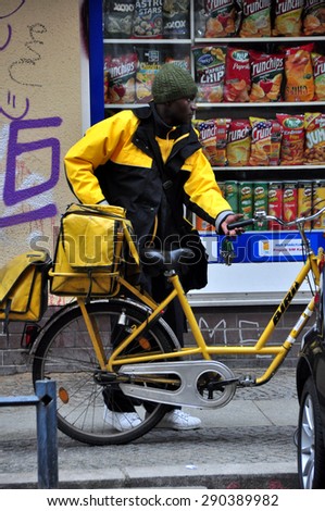 BERLIN MARCH 6: Postman on a bicycle (over 15% people in Berlin prefer moving by bike) on March 6, 2015.