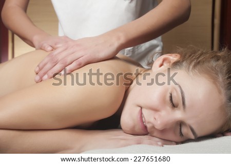 a young woman is receiving a massage, as anti-stress treatment