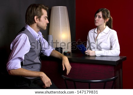 young businessman ordering coffee from female waitress