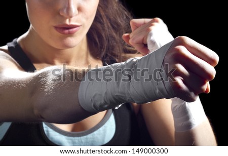 Female Mma Fighter Punching. Black Background