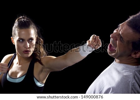 young fit woman fighting a man. battle of the sexes.