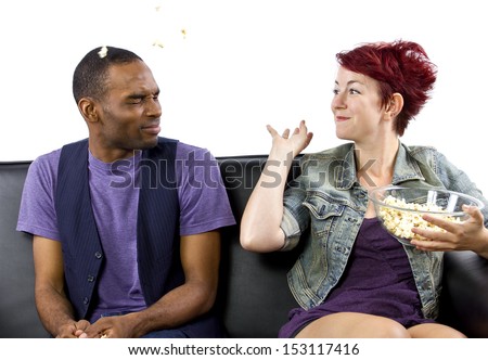 multi-racial male and female roommates sharing a couch