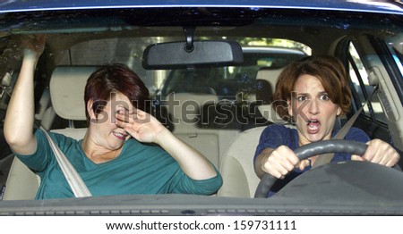 reckless driver and scared female passenger in a car
