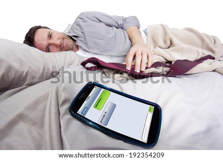 ... phone screen showing text messages while male is in bed - stock photo