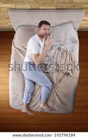 top view of bedroom with insomniac man unable to sleep