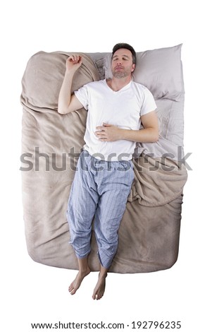 top view of sleep deprived man on a bed