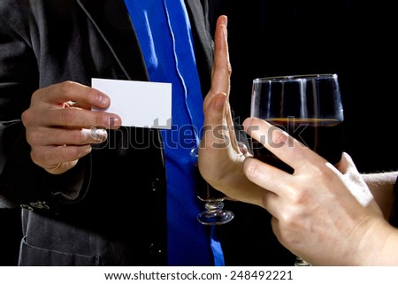 businessman handing over business card to a female at a bar