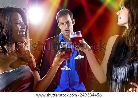 women seducing a man to buy them cocktails at a nightclub