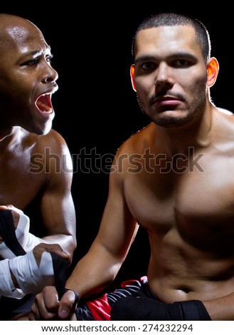 Trainer motivating a muscular Boxer or MMA fighter with pep talks