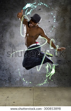 Jumping muscle man stylized with lights and graphics to show energy. He is active and in motion on a concrete background.