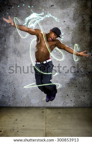 Jumping muscle man stylized with lights and graphics to show energy. He is active and in motion on a concrete background.