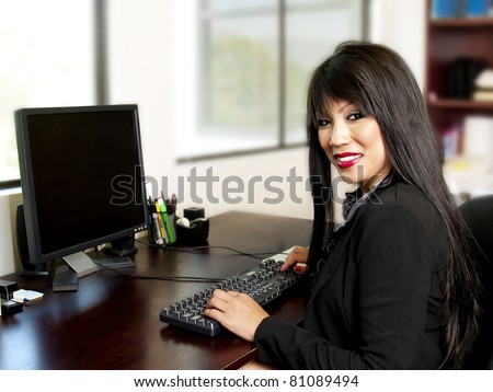 Asian female office secretary typing on a keyboard