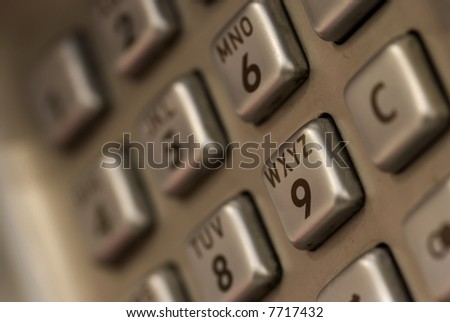 Phone key from a puplic call phone, telecommunications background, shot on macro lens, with sDOF and focus on the 9, slight tint add for effect.