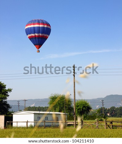 Hot air balloon landing in a field in Vic, Spain.