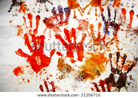color hand prints painted on a white wall