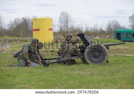 ST. PETERSBURG, RUSSIA - MAY 05, 2015: German gunners with anti-tank gun. Reconstruction of the episode of the Great Patriotic War