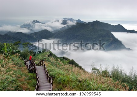 A man looking at a fog filled valley.