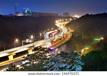 Brightly lit roads leading in and out of a city.