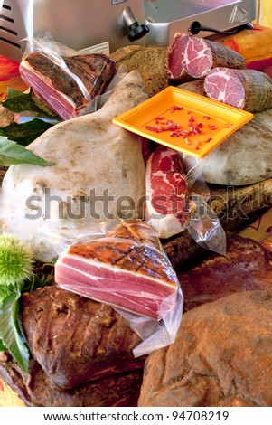Smoked ham displayed on market stall