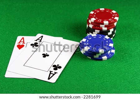 Playing cards showing a pair of aces with poker chips next to them