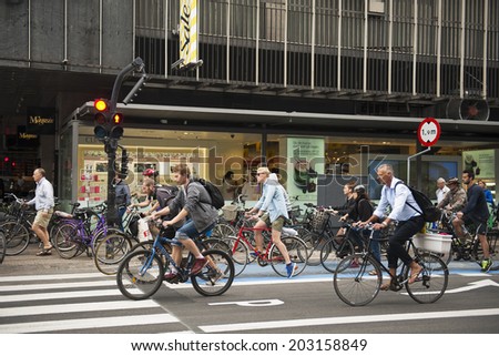 COPENHAGEN, DENMARK - JULY 2: Many people biking in centre of city on July 2, 2014 in Copenhagen