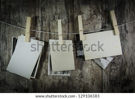 Design template - retro still old photos hanging on a clothesline on wooden table background