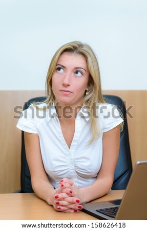 Portrait of businesswoman thinking about something whith laptop