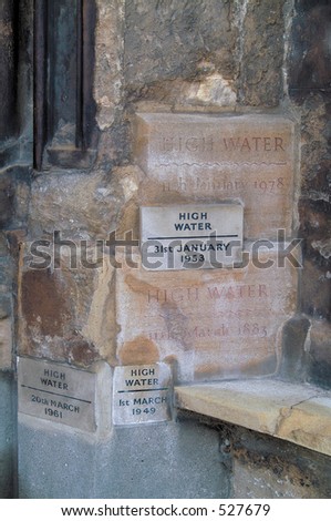 Stone markers of past flood levels at a church in King\'s Lynn, Norfolk.
