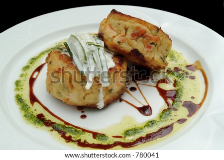 Pan-fried spiced salmon fishcake with a cucumber and yoghurt sauce, drizzled with pesto and balsamic vinegar. Enjoy.